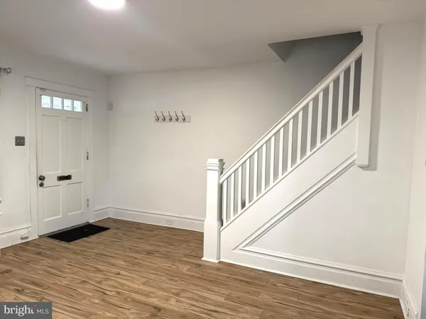 a view of an entryway with wooden floor