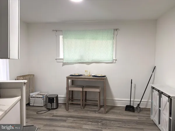 a view of a workspace with furniture and wooden floor