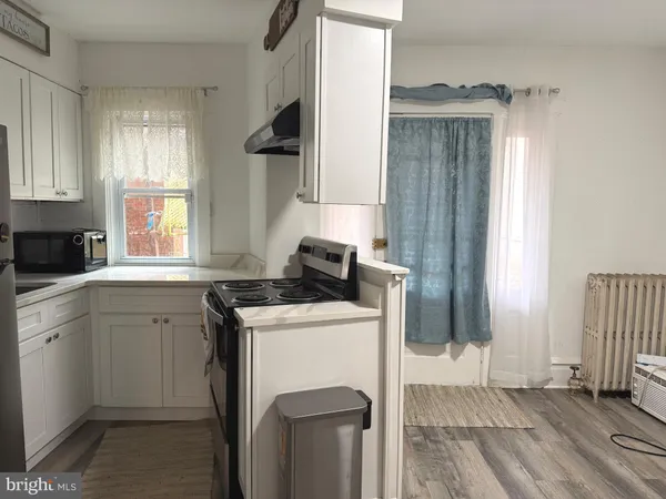 a kitchen with a stove a sink and a refrigerator