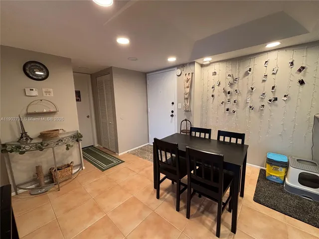 a kitchen with stainless steel appliances kitchen island granite countertop a refrigerator and a stove top oven