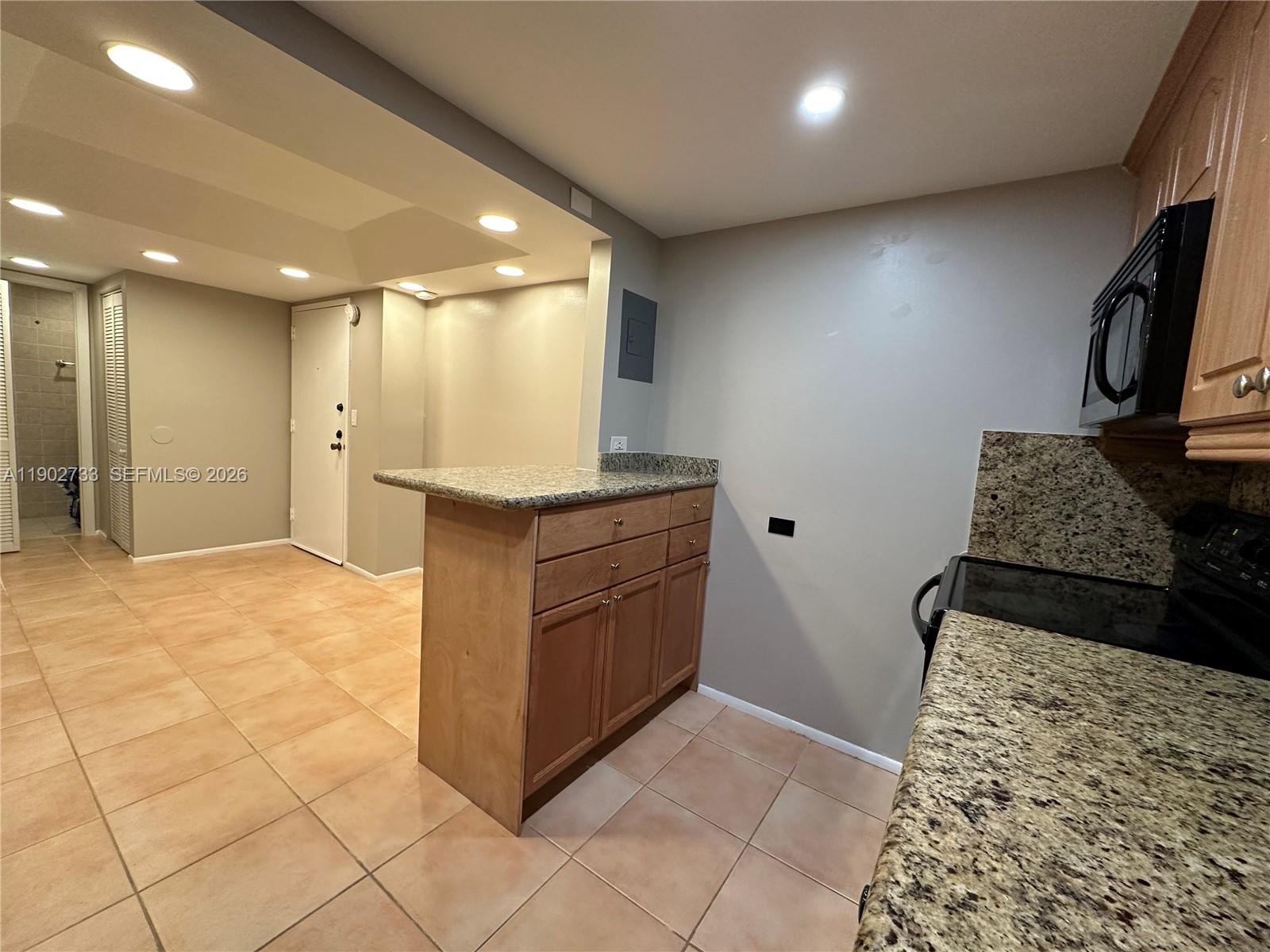 3650 Inverrary Drive, Unit 3YG Lauderhill, FL 33319 - Photo 9 of 30 a kitchen with stainless steel appliances granite countertop a refrigerator and a stove