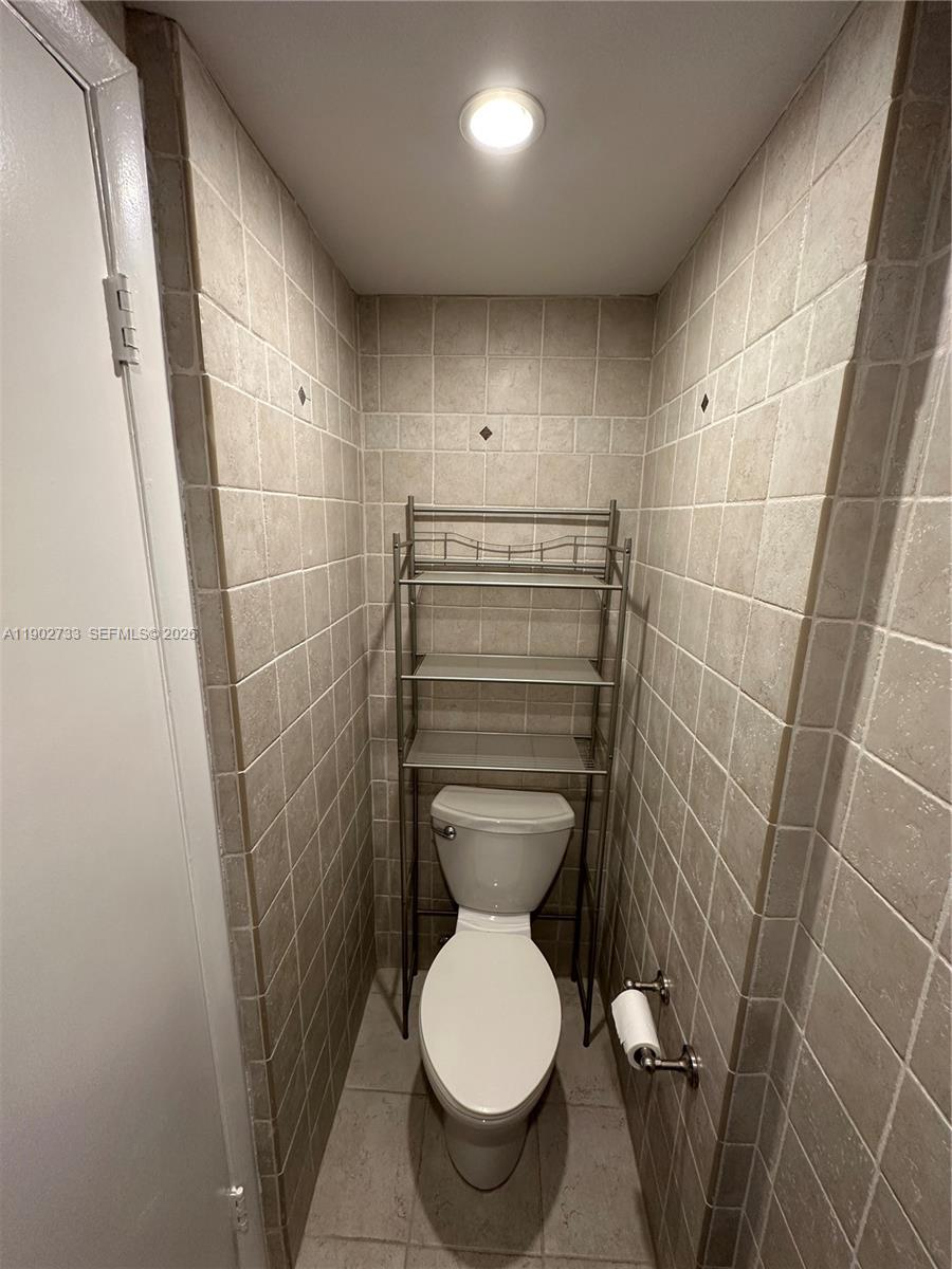 3650 Inverrary Drive, Unit 3YG Lauderhill, FL 33319 - Photo 10 of 28 a bathroom with a toilet and a shower