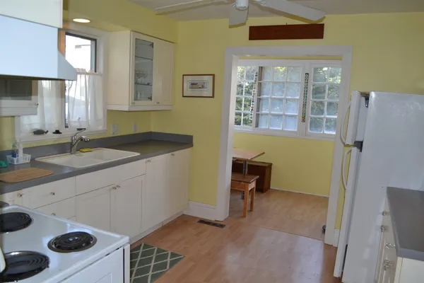 a kitchen with a sink a stove and cabinets