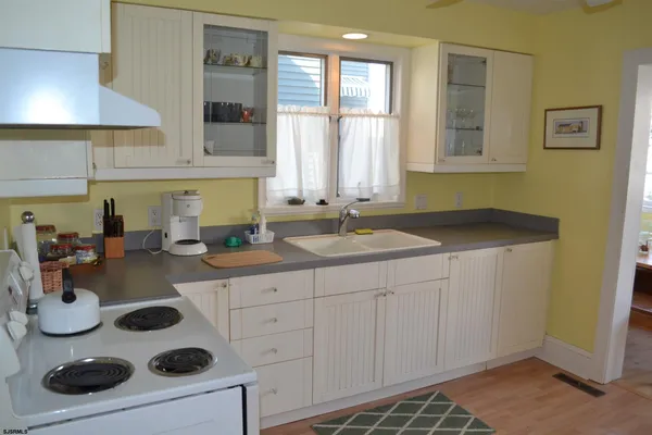 a kitchen with a refrigerator sink and cabinets