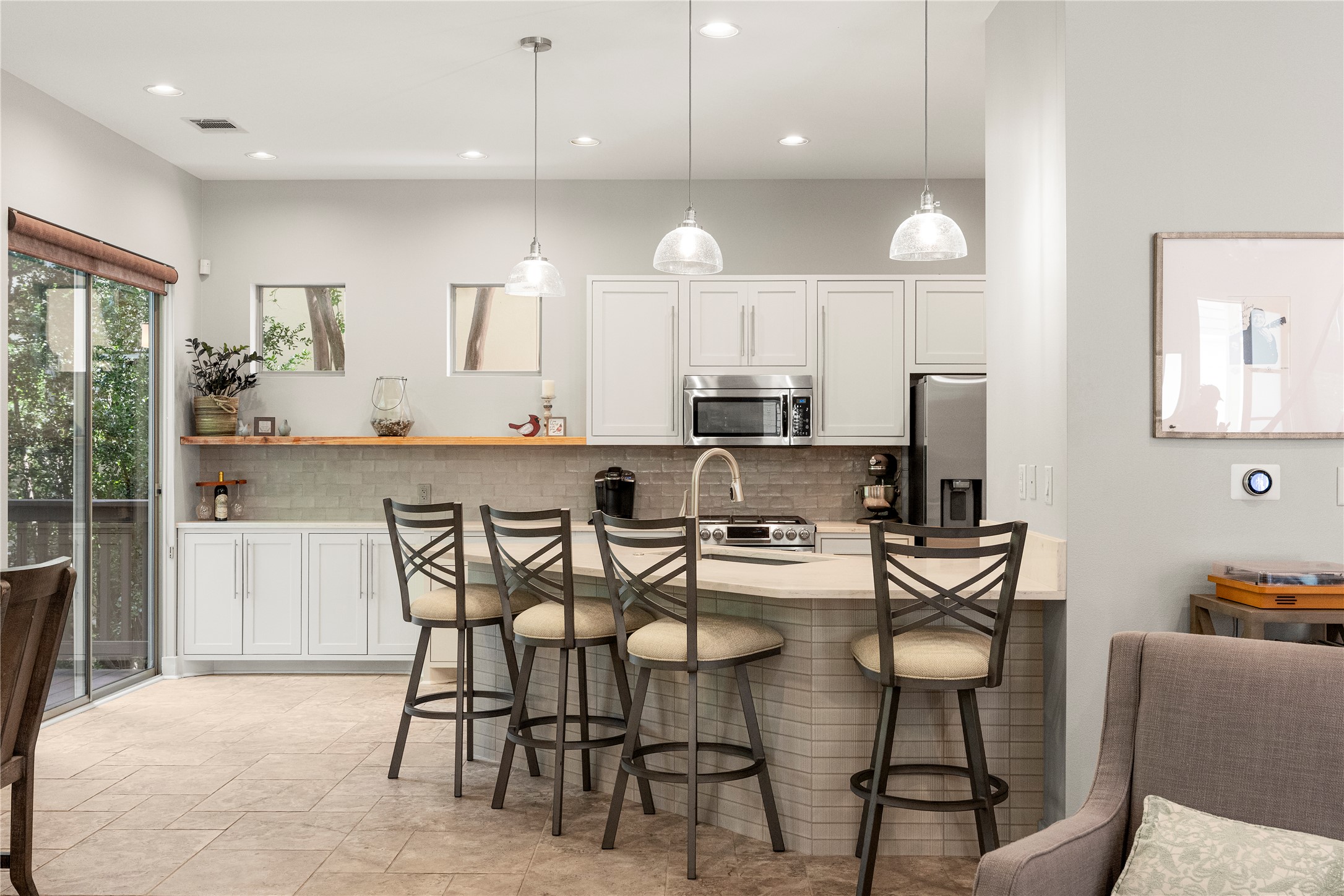 3814 Ridgelea Drive, Unit A Austin, TX 78731 - Photo 2 of 30 a kitchen with stainless steel appliances kitchen island granite countertop a dining table chairs and sink