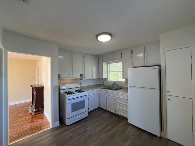 a kitchen with a refrigerator sink and stove