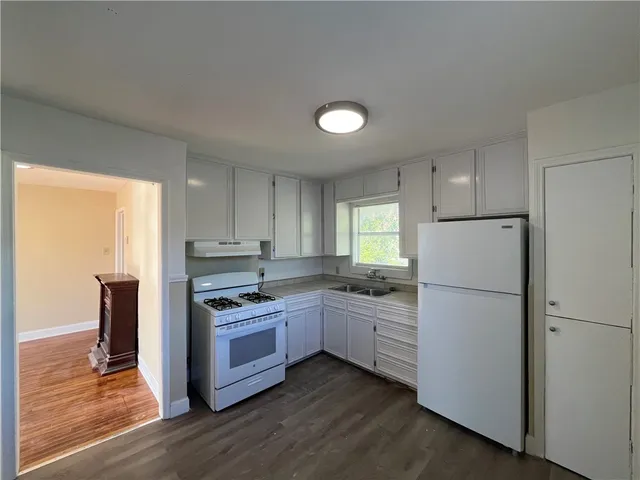 a kitchen with stainless steel appliances granite countertop a refrigerator stove a sink and dishwasher