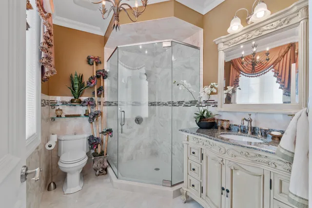 a bathroom with a granite countertop sink toilet and shower