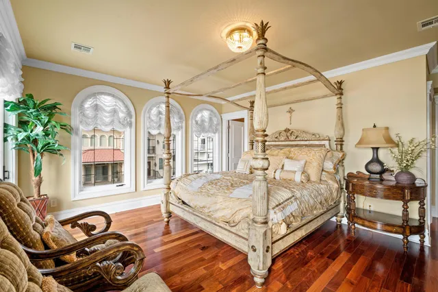a bedroom with a bed and a chandelier