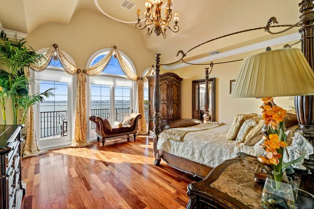 a bedroom with furniture and a chandelier