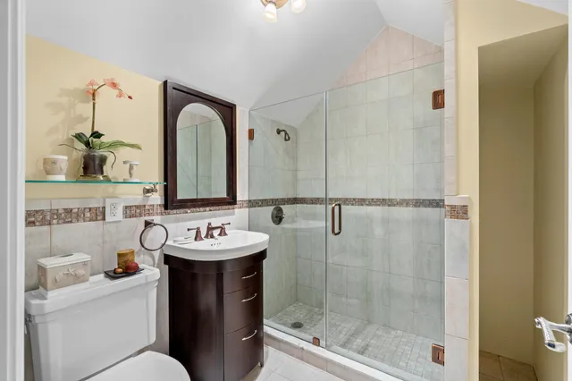 a bathroom with a sink toilet and shower