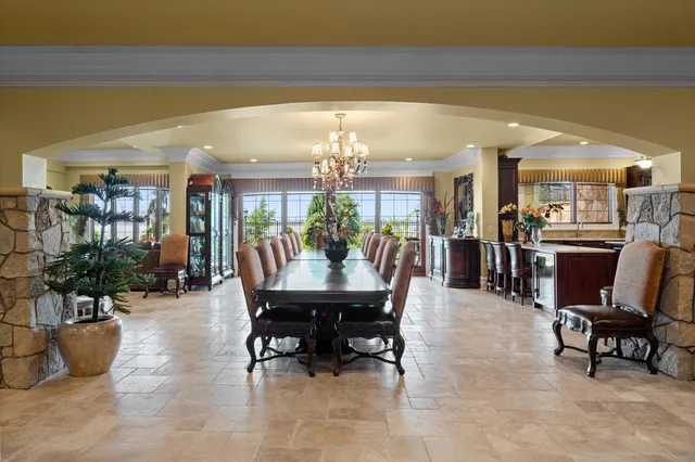 a view of a dining room with furniture and chandelier