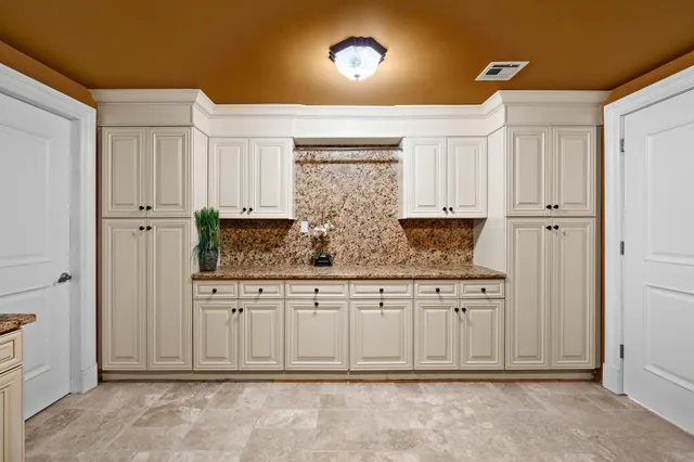 a view of a kitchen with granite countertop cabinets