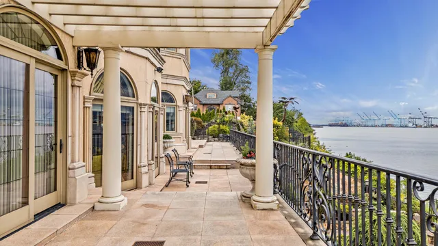a view of a balcony with wooden floor and furniture
