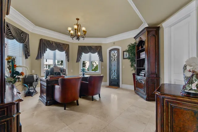 a living room with furniture a chandelier and a fireplace