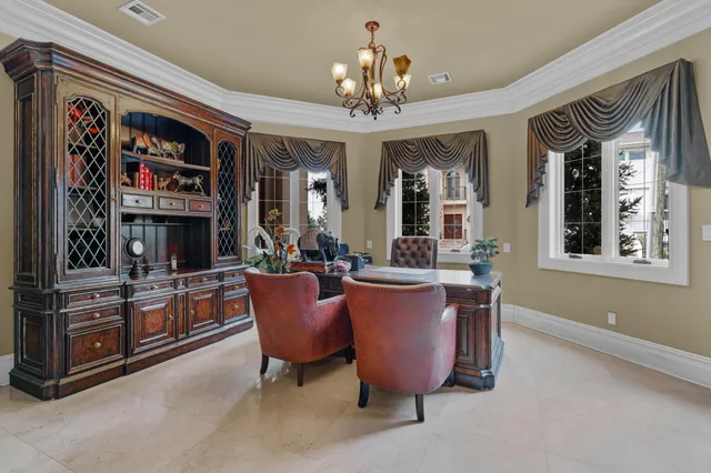 a view of a dining room with furniture and chandelier