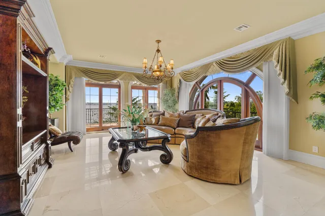a living room with fireplace furniture and a large window