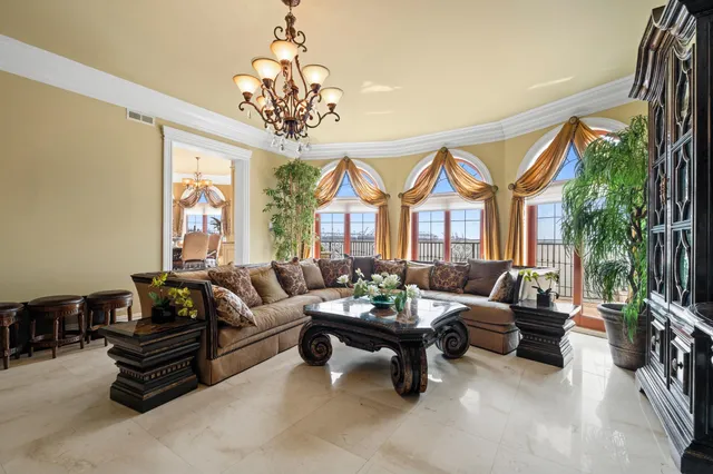 a living room with furniture and a chandelier