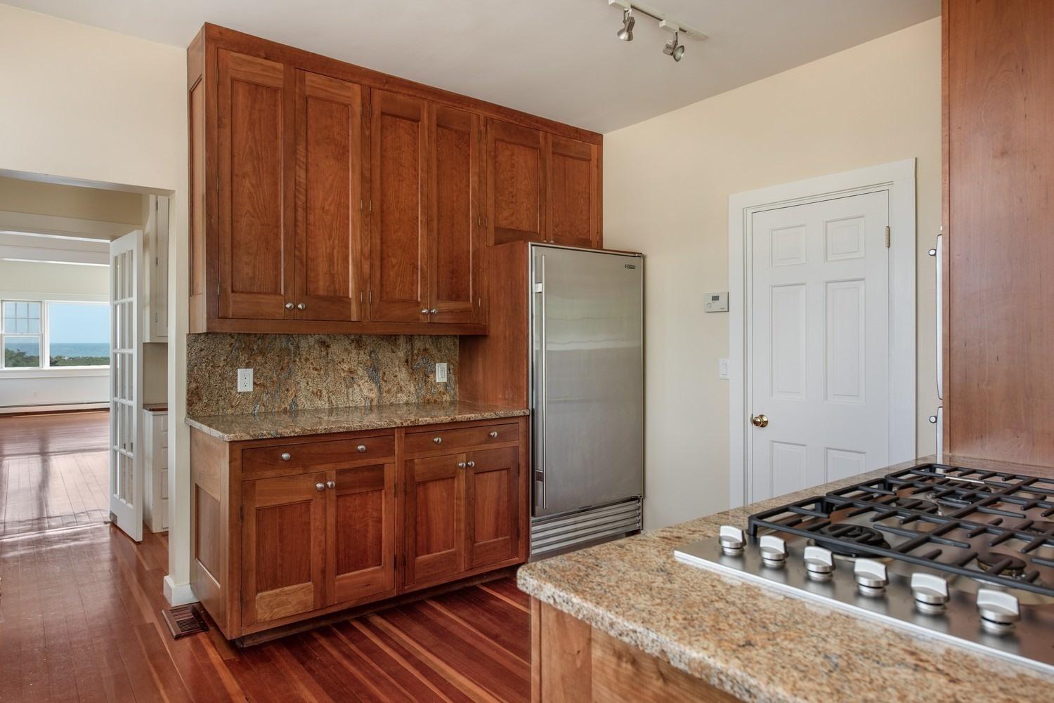 773 South Main Street Centerville, MA 02632 - Photo 13 of 33 a kitchen with granite countertop a stove and a refrigerator