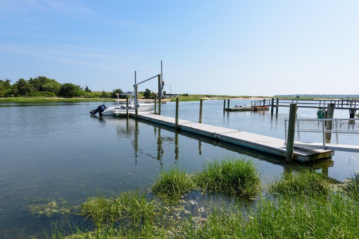 773 South Main Street Centerville, MA 02632 - Photo 22 of 33 a view of a lake with boats and a bridge