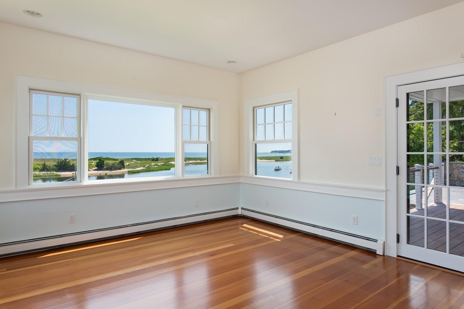 773 South Main Street Centerville, MA 02632 - Photo 8 of 33 an empty room with wooden floor and windows