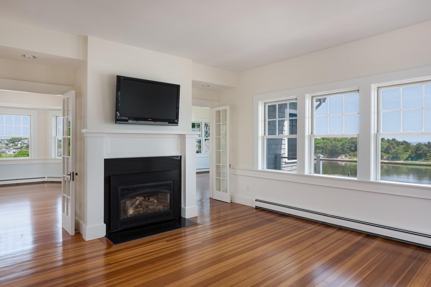 773 South Main Street Centerville, MA 02632 - Photo 10 of 33 a living room with a fireplace and a flat screen tv