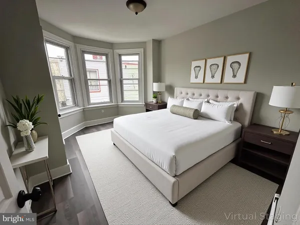 a bedroom with a large bed and a chair