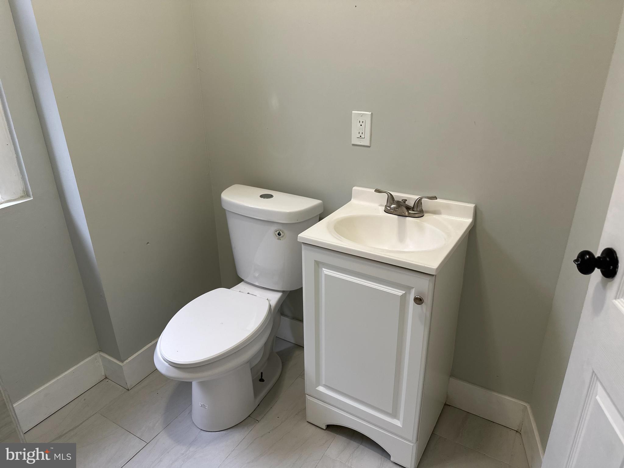 5729 Pine Street, Unit 2 Philadelphia, PA 19143 - Photo 18 of 21 a white toilet sitting next to a bathroom sink