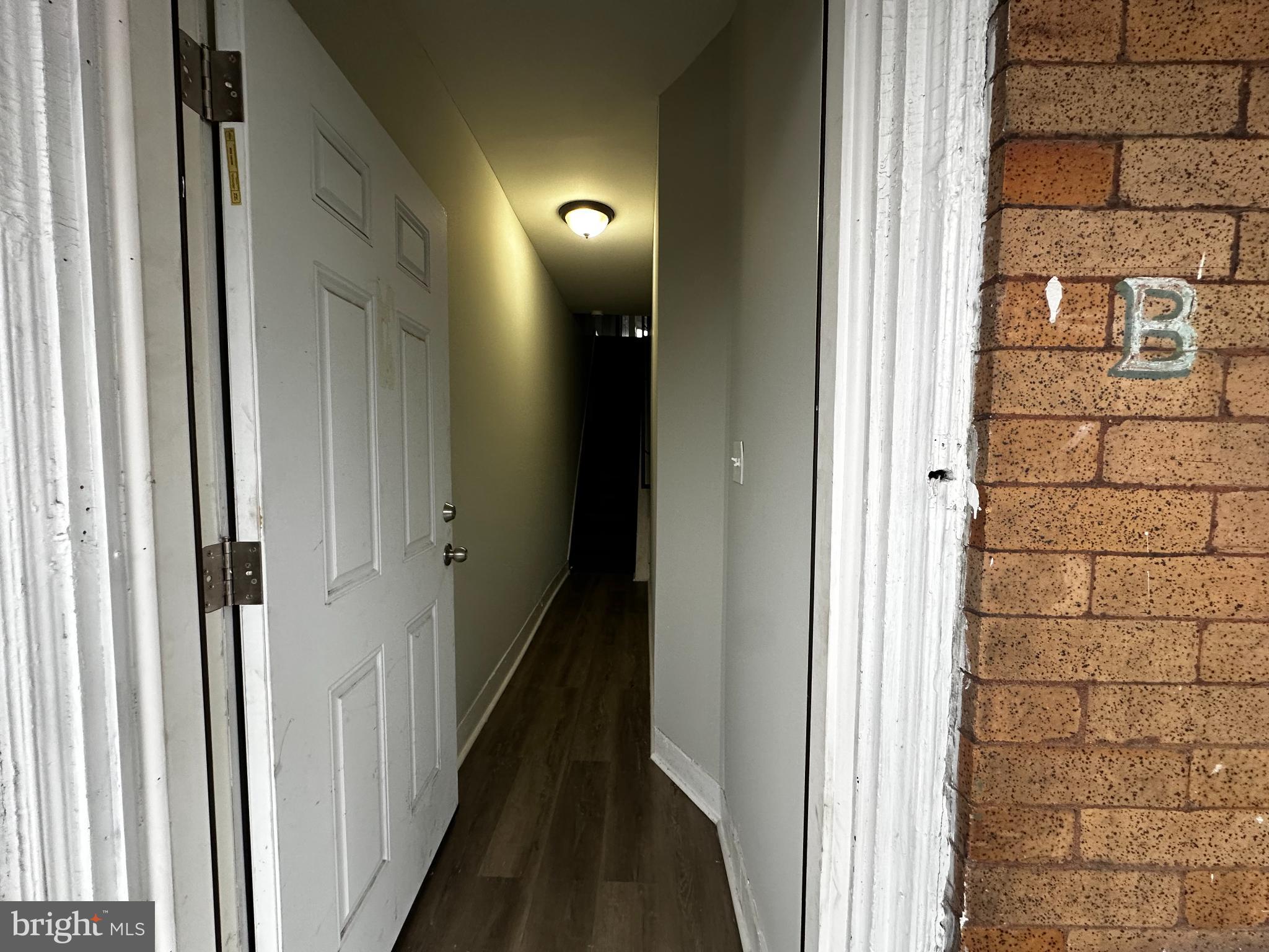 5729 Pine Street, Unit 2 Philadelphia, PA 19143 - Photo 19 of 21 a view of a hallway with a wooden door