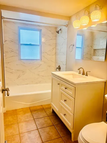 a view of a kitchen with kitchen island wooden floor and a large window