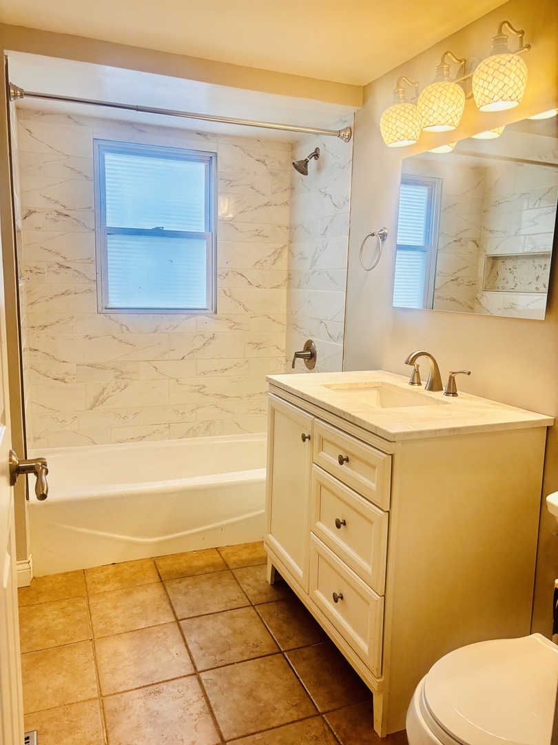 1514 173rd Street East Hazel Crest, IL 60429 - Photo 13 of 20 a bathroom with a sink a toilet and shower