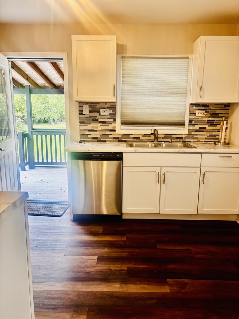 1514 173rd Street East Hazel Crest, IL 60429 - Photo 14 of 20 a view of a kitchen with kitchen island wooden floor and a large window