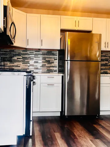 a room with wooden floor and white walls