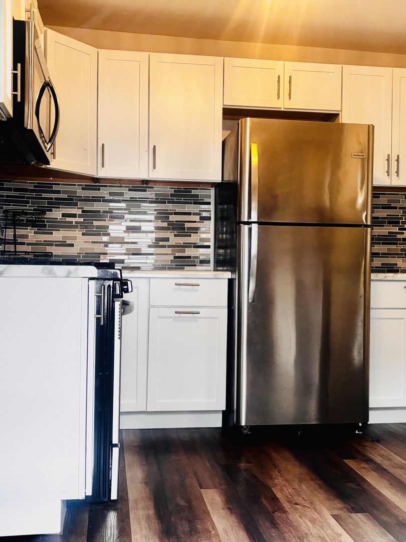 1514 173rd Street East Hazel Crest, IL 60429 - Photo 16 of 20 a kitchen with stainless steel appliances granite countertop a refrigerator sink and cabinets