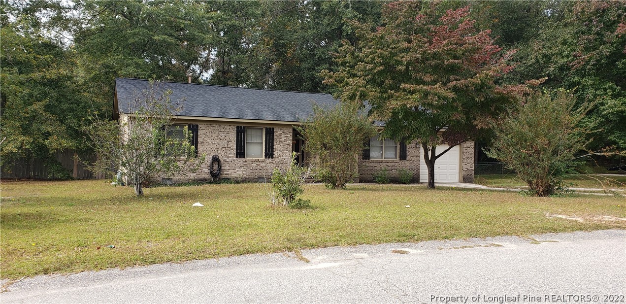 6716 Vaughn Road Fayetteville, NC 28304 - Photo 2 of 5 a house that has a tree in front of it