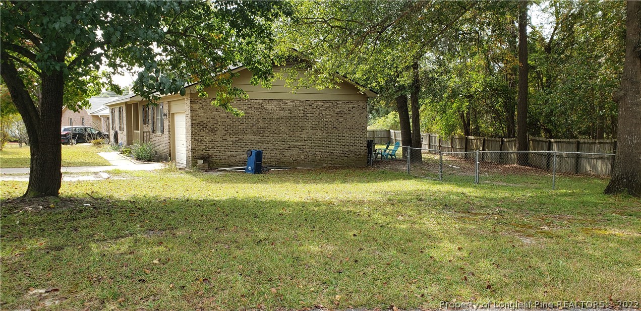 6716 Vaughn Road Fayetteville, NC 28304 - Photo 4 of 5 a view of a yard with a house and large tree