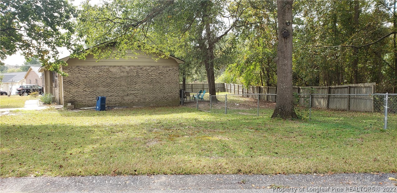 6716 Vaughn Road Fayetteville, NC 28304 - Photo 5 of 5 a view of a yard with a tree
