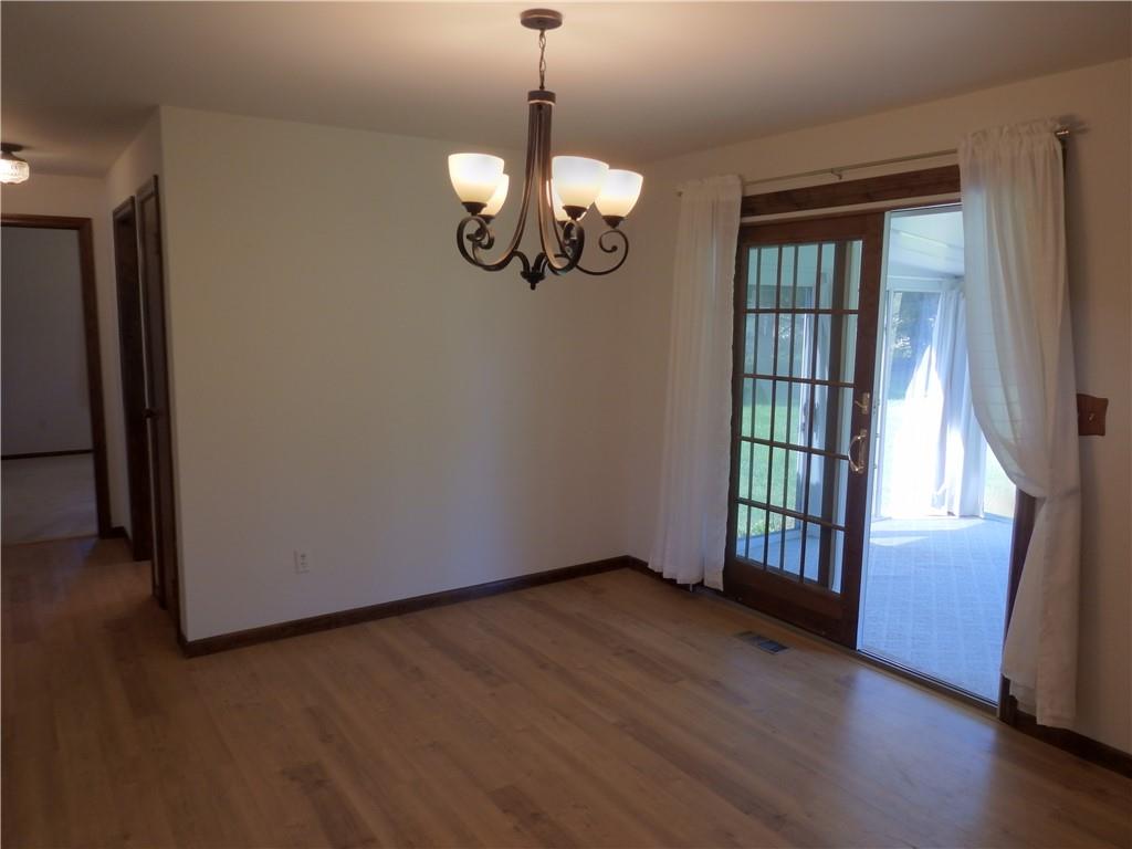 7111 Country Club Road Butler, PA 16001 - Photo 11 of 25 a view of an empty room with wooden floor and a window