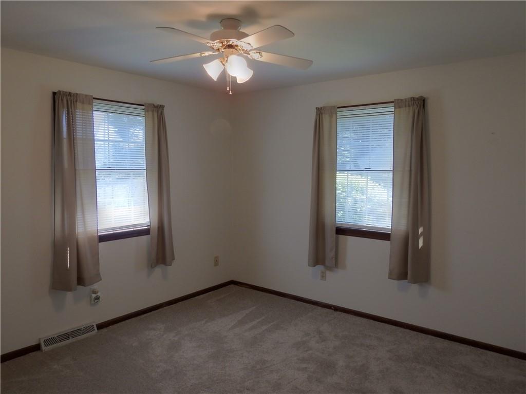 7111 Country Club Road Butler, PA 16001 - Photo 17 of 25 an empty room with windows and fan