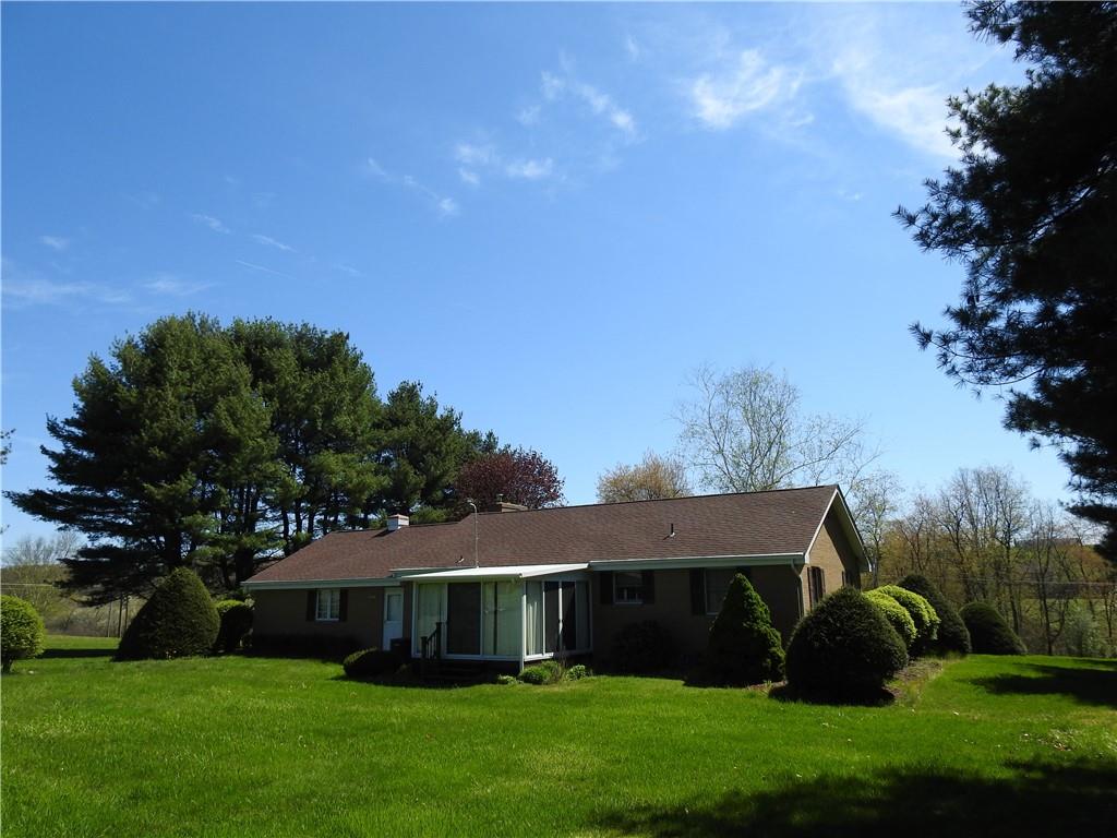 7111 Country Club Road Butler, PA 16001 - Photo 3 of 25 a front view of a house with a garden and yard