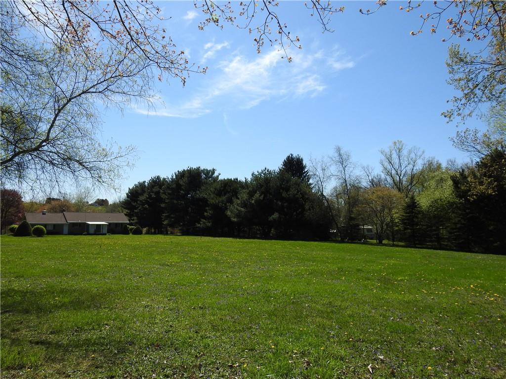 7111 Country Club Road Butler, PA 16001 - Photo 6 of 25 a view of a grassy field with trees in the background