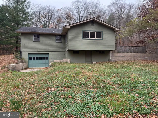 a house with lots of trees in the background