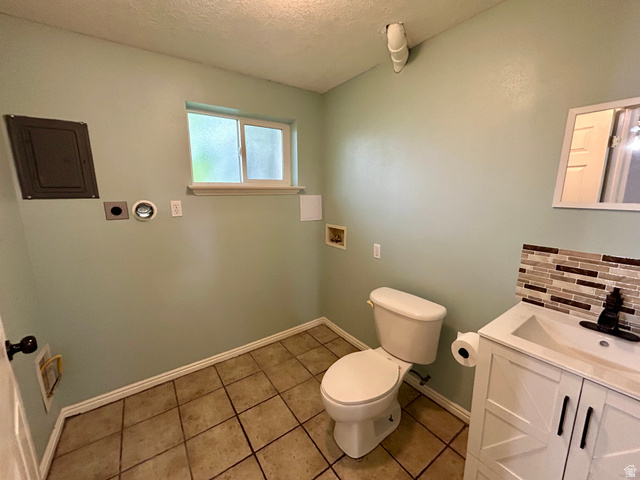 441 South 400 East Payson, UT 84651 - Photo 23 of 39 Full bathroom featuring a white vanity with integrated sink, mosaic tile backsplash, and ceramic tile flooring