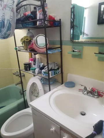 a bathroom with a toilet and shower curtain