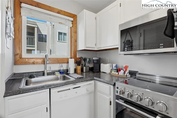 a kitchen with a sink cabinets and appliances