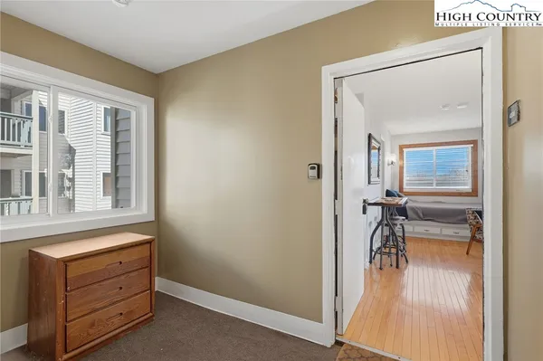 a view of hallway with a flat tv screen and dresser