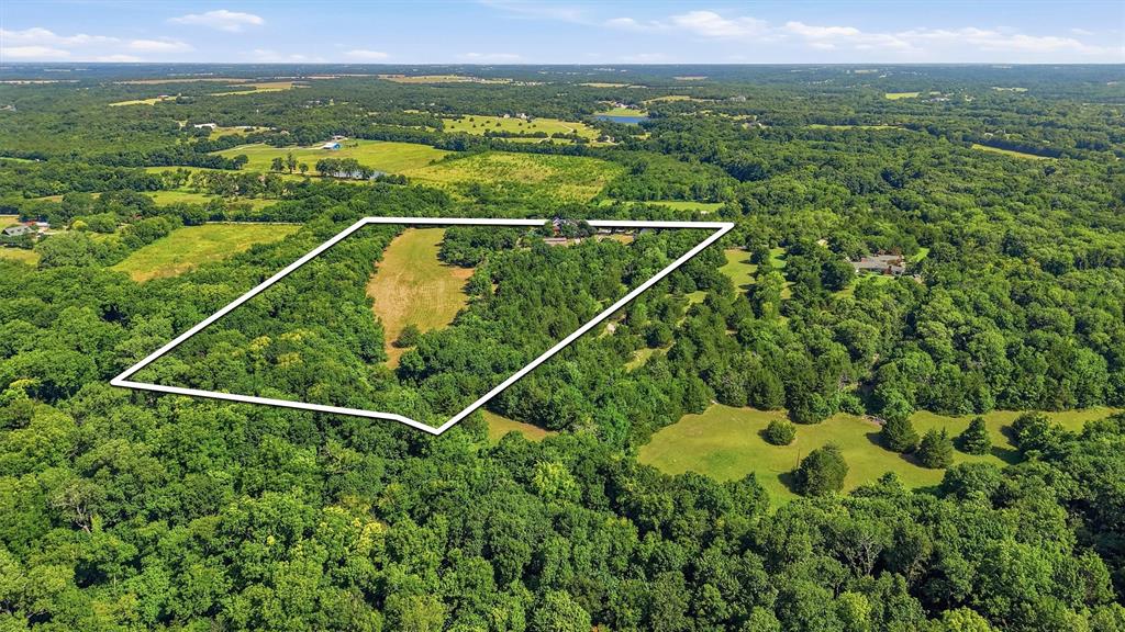 3260 Bethel-Cannon Road Van Alstyne, TX 75495 - Photo 40 of 40 Expansive aerial view of a verdant property outlined in white, featuring significant tree coverage and open grassy areas