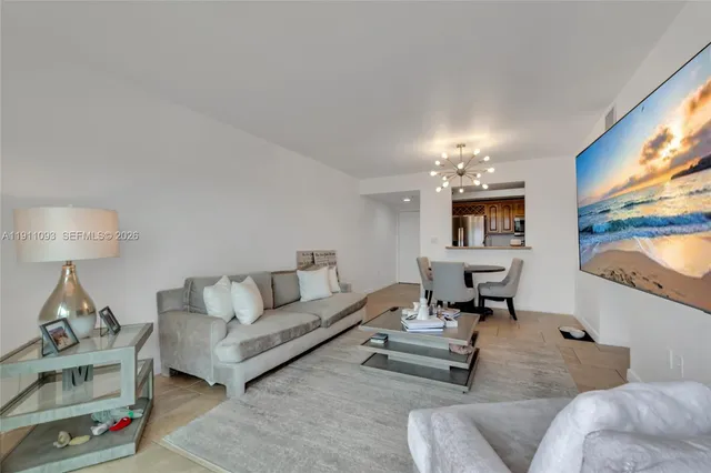 a living room with furniture a rug and a floor to ceiling window