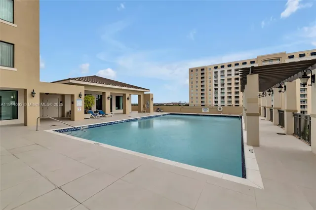 a view of roof deck with outdoor seating and city view