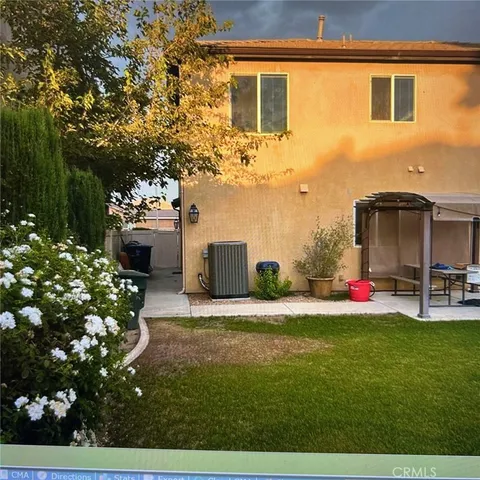 a view of a house with a yard and garden